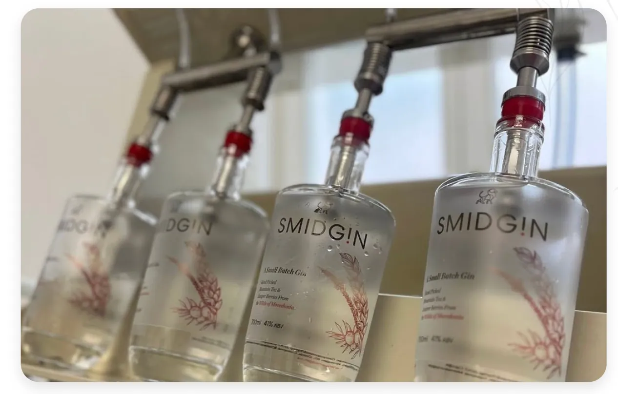 Smidgin bottles on the filling line, each finished by hand and sealed with red wax
